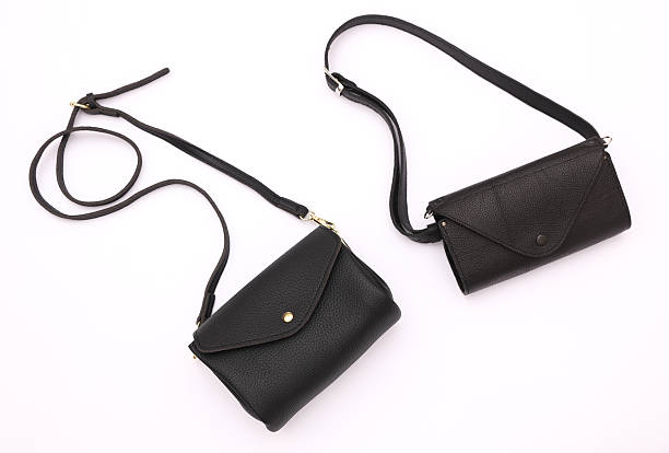 istock Two leather black bags with straps, white background 2248348470