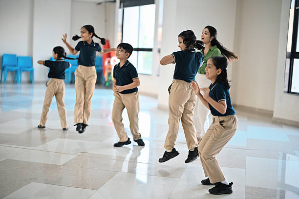 istock School Teacher Leading Students in a Fun Dance Activity 2248350366