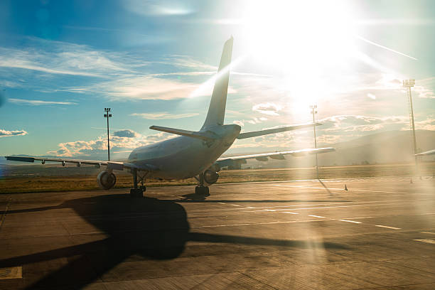 istock Dramatic Backlit View Of Passenger Airplane At Sunrise 2248352186