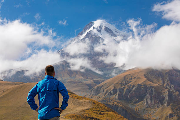 istock Man Standing Back View Looking At Mount Kazbek Snow Capped Peak 2248352328