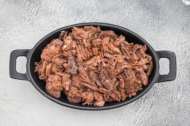 istock Tender slow cooked venison and elk stew with herbs in a cast iron dish on a light textured background for rustic gourmet food concepts. 2248352841