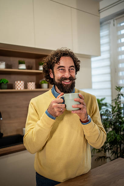 istock Happy man enjoying coffee in modern kitchen 2248353842