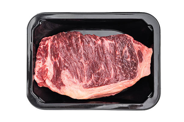 istock Prime New York strip steak in packaging on bright white surface, showcasing marbled beef cut for grilling, roasting or culinary content 2248354475