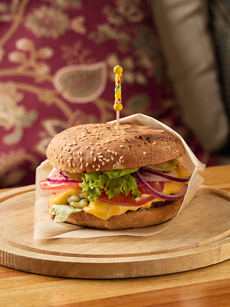 istock delicious burger display, enticing image of hearty cheeseburger with crisp toppings on rustic background 2248355160