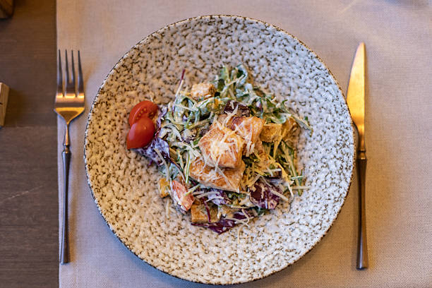 istock Fresh caesar salad with grilled chicken and cherry tomatoes in rustic ceramic bowl 2248355773