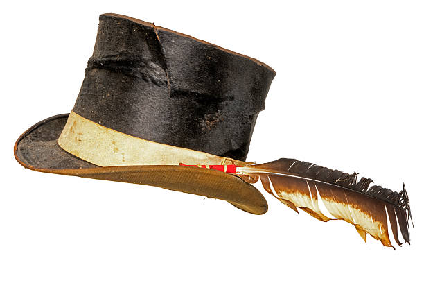 Cowboy holds up a revolver in one hand standing in front of the white background
