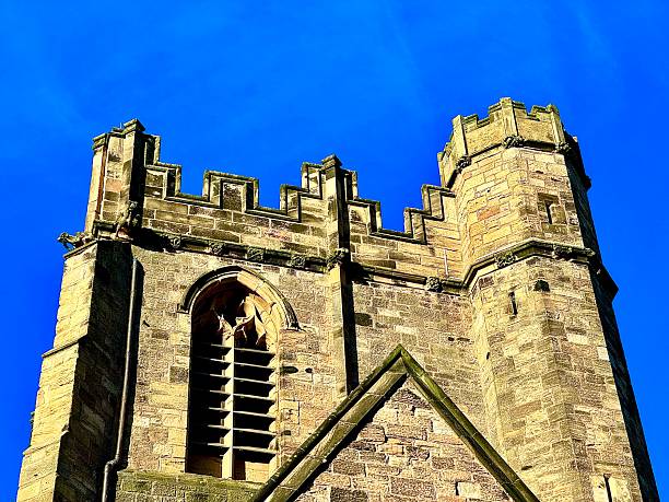 Low angle view of a church tower against blue sky