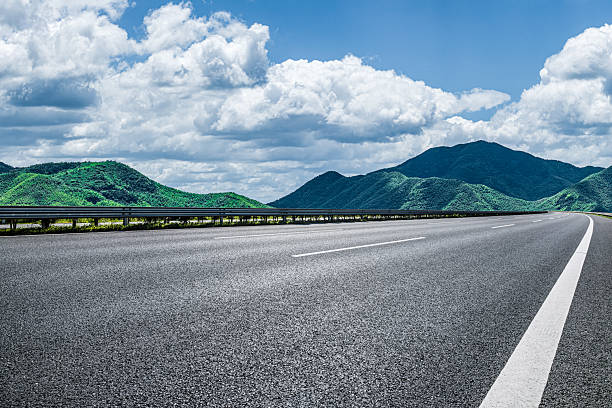 istock Empty asphalt highway road and green mountain natural landscape under blue sky and white clouds. 2248358158