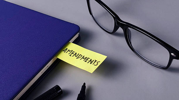 istock Amendments Note in Blue Notebook with Glasses: Legal Change, Policy Review, and Editing Concept 2248358611