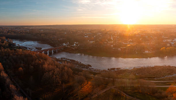 istock Kuldiga Latvia sunset over Venta River and red brick bridge arches 2248358833
