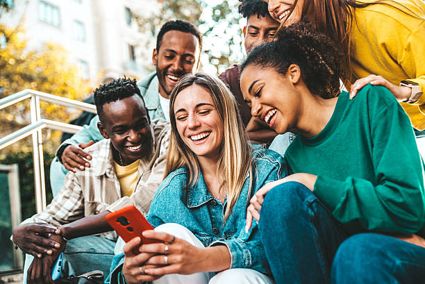 istock Happy young people having fun watching smart mobile phone device - Technology life style concept 2248360577