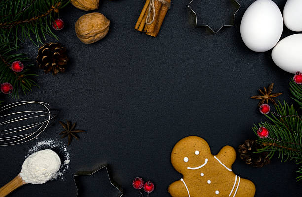 istock Christmas baking concept. Ingredients for baking, gingerbread man and Christmas decor on a black background. Flatlay composition. Top view. Copy space. 2248361005