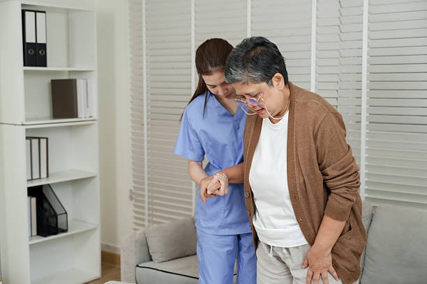 istock Asian female physiotherapist closely guiding senior woman step by step while practicing walking and focusing on posture correction during recovery therapy session in clinic 2248361508