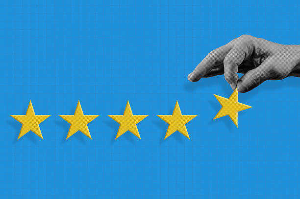 istock Hand holds gold five star rating. Halftone collage Five star for quality customer rating. 2248363351