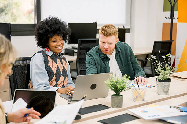istock Diverse business colleagues collaborating on laptop in modern office 2248363730