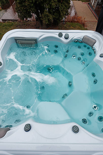 istock White rectangular hot tub with jets on a residential patio in daylight 2248364555