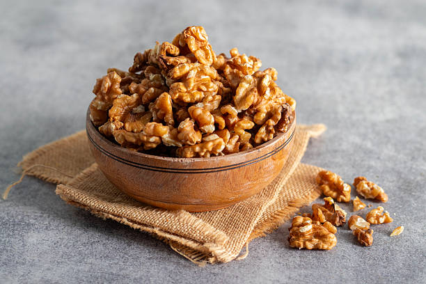 istock Walnuts are crunchy, brain-shaped nuts rich in omega-3, antioxidants, and protein, promoting heart, brain, and overall body health. 2248365267