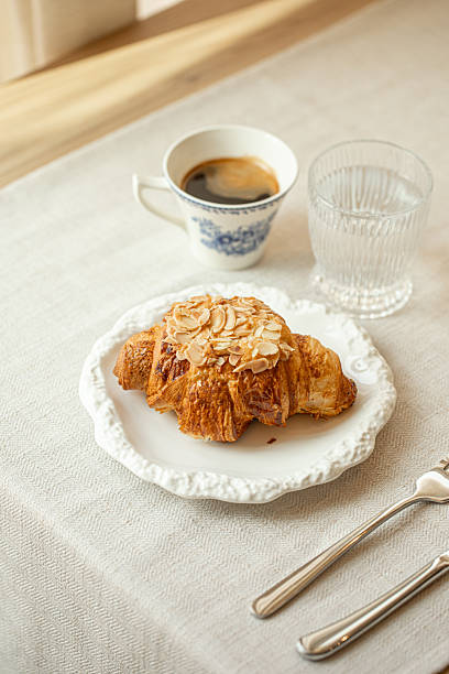 istock Almond croissant served with coffee on white plate 2248365513
