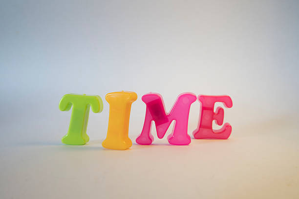 Colorful Plastic Letter TIME Word on White Background