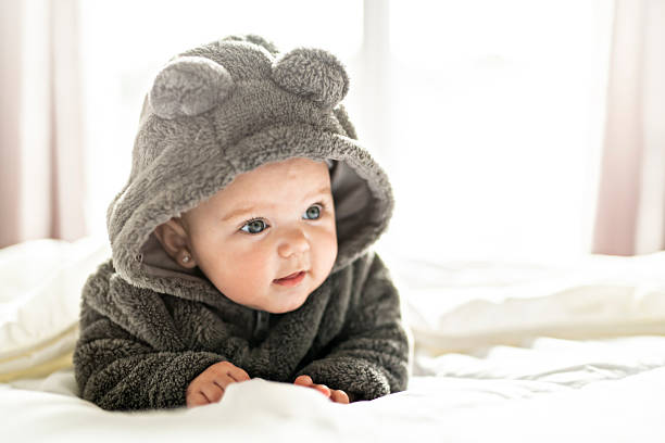 istock A Cute baby girl on a white bed at home 2248366877