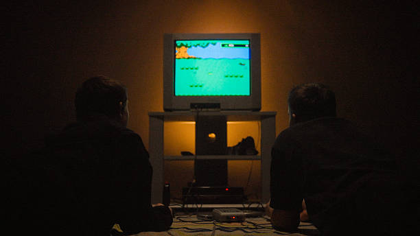 istock Siblings playing a video game on an old school retro console together at night 2248367883