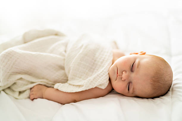istock A 4 month baby sleeping on a white bed at home 2248368040