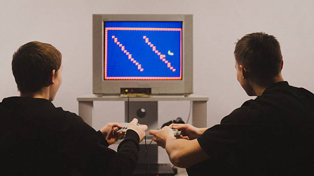 Siblings playing games on a retro CRT TV game system. Old school 8-bit games from the past. Photography grain effect