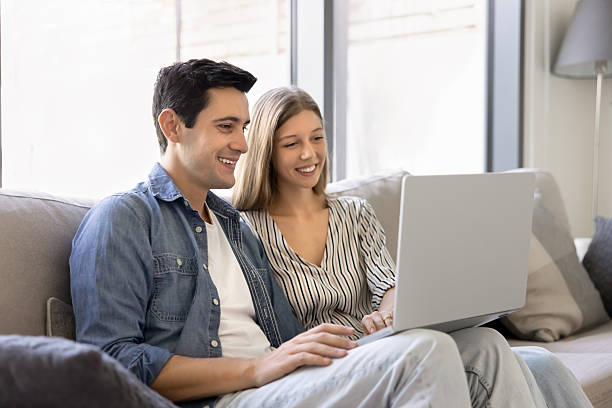 istock Beautiful young couple do online shopping using laptop 2248368224