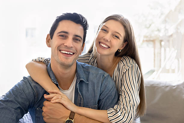 istock Hispanic couple hugging, laughing, staring at camera with joyful expression 2248368388