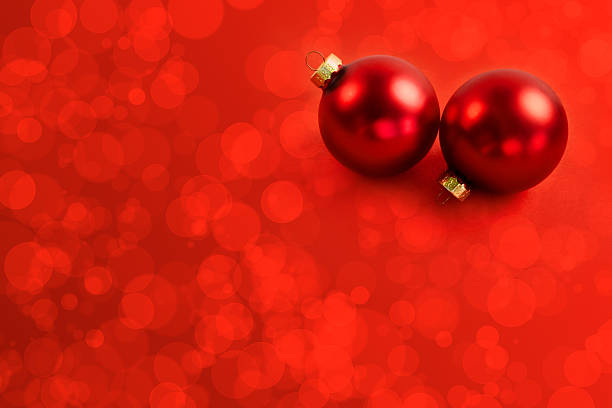 red christmas balls with bright red bokeh background