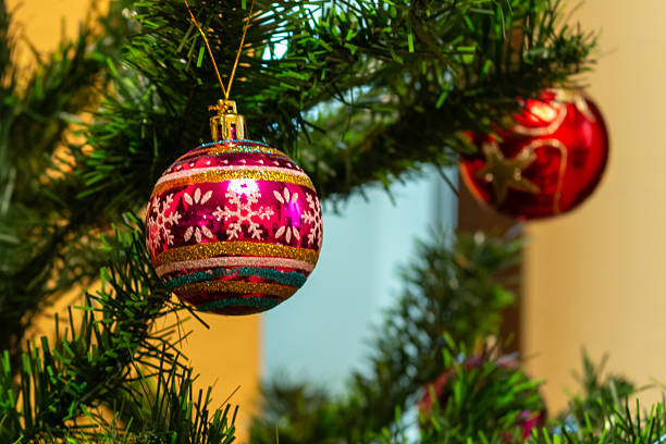 Christmas decorations with colorful ornaments, glowing lights, festive tree baubles, tinsel and garlands, holiday interior setup, winter seasonal decor, cozy home ambiance, sparkling festive details in indoor setting