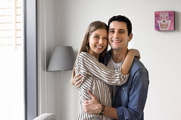 istock Couple embraces each other warmly standing in modern home interior 2248369288