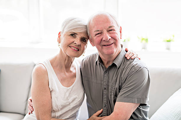 istock Affectionate attractive elderly couple sitting together on a couch 2248369965