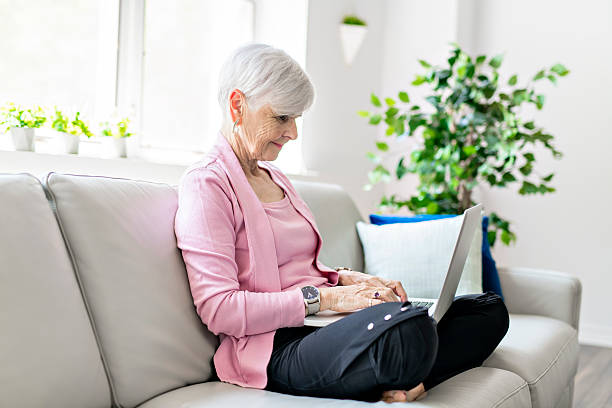 istock Retired senior woman sitting at home using her laptop 2248370023