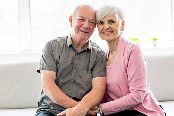 istock Affectionate attractive elderly couple sitting together on a couch 2248370043