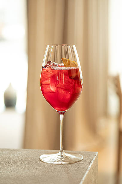 istock Red cocktail with orange and ice in wine glass 2248371192