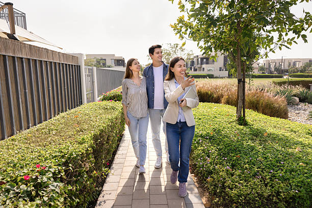 istock Agent guiding young couple showcasing new home or community features 2248373390