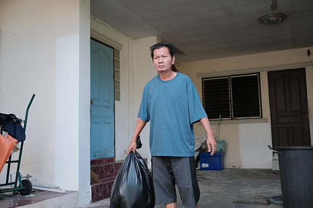 portrait of man with garbage bags in park