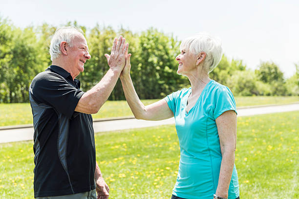istock Senior couple running in park doing high five 2248376935