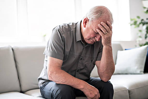 istock senior man thinking and sitting on sofa at home like sad 2248376985