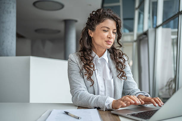 istock Businesswoman typing on laptop in modern office 2248377196