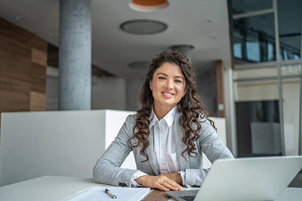 istock Confident businesswoman smiling at camera in office 2248377197