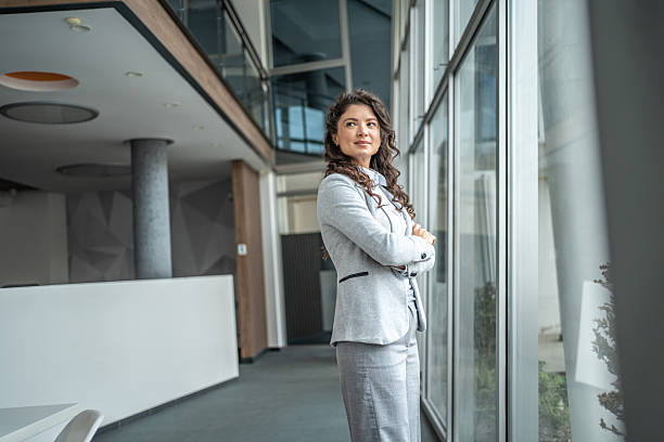 istock Confident businesswoman looking out office window 2248377370