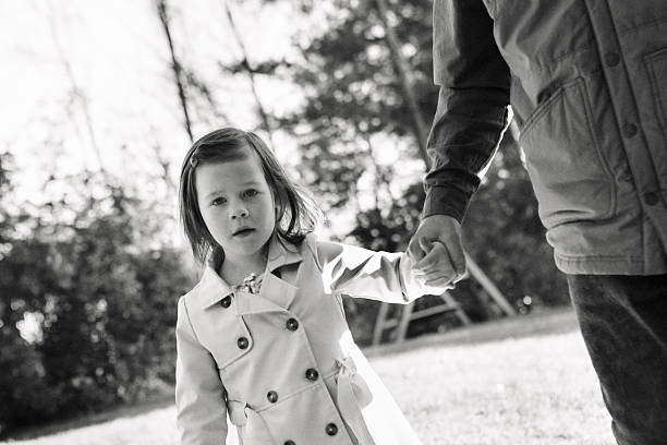 istock Father and Young Daughter Walking Outside Holding Hands 2248378379
