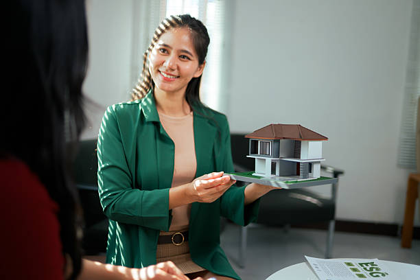 istock Real estate agent discussing property details and future home purchase with a client during an in-person meeting 2248379059