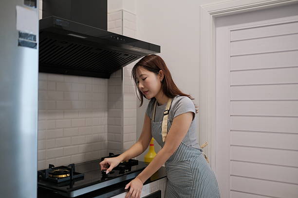 istock A woman is cooking in a kitchen with a yellow apron on 2248380133
