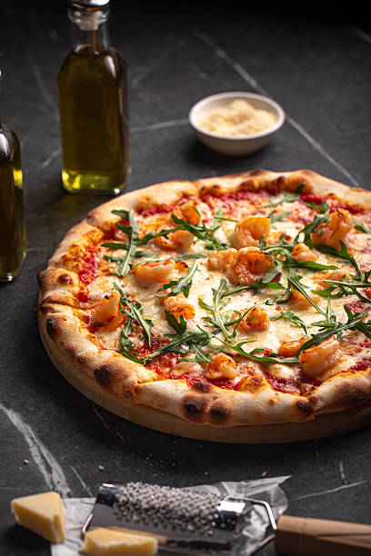 istock Shrimp and arugula pizza with cheese and sauce 2248380596