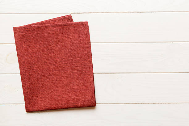 istock top view with red empty kitchen napkin isolated on table background. Folded cloth for mockup with copy space, Flat lay. Minimal style 2248381062