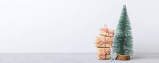 istock Christmas composition. Gifts, small tree, branches and craft DIY decorations on white background. New year concept. Christmas home decoration Flat lay, top view, copy space 2248381074