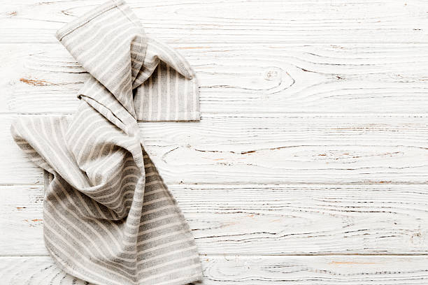istock top view with gray kitchen napkin isolated on table background. Folded cloth for mockup with copy space, Flat lay. Minimal style 2248381104